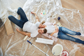 Paar schläft erschöpft auf dem Fußboden