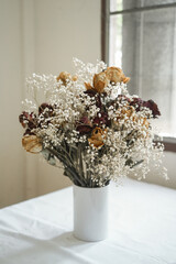 a bouquet of dry roses and gypso flowers 