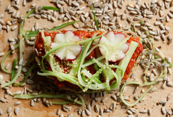 A sandwich with vegetables and seeds, close up 