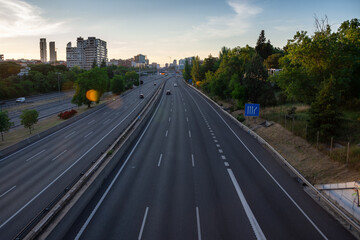 View from a motorway bridge at dusk with little traffic, horizontal