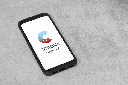 Galicia, Spain; june 18, 2020: German Corona Warn App in mobile phone on grunge concrete background. Copy space