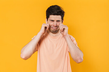 Photo of unhappy bristle man in basic t-shirt crying on camera