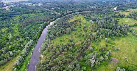 Summer nature landscape with river and lush forest from aerial view. Scenery panorama.