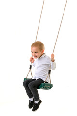 Cute Blond Boy Swinging on Rope Swing and Looking at Camera
