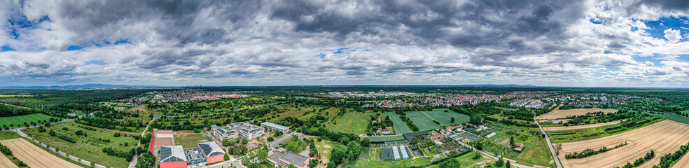 Fototapeta na wymiar Panoramic drone picture of the city Moerfelden-Walldorf with the skyline of Frankfurt in the background at evening