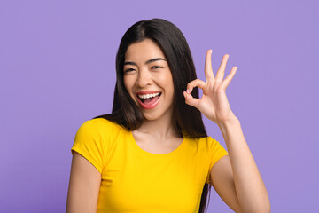 Everything Is Great. Joyful Asian Woman Showing Ok Sign Over Purple Background