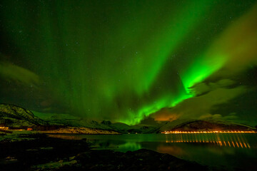 Dramatic aurora borealis, polar lights, over mountains in the North of Europe - Lofoten islands, Norway