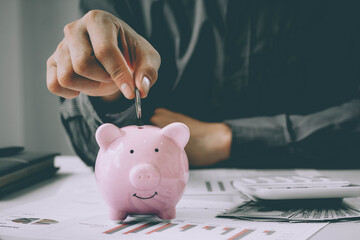 Man putting coin in piggy bank. saving money, budget, investment, finance concept