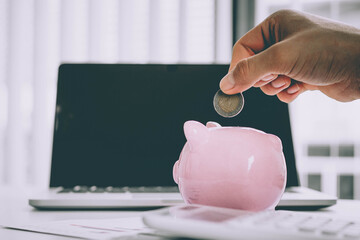 Man putting coin in piggy bank. saving money, budget, investment, finance concept