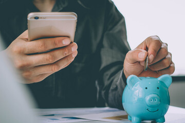 Man putting coin in piggy bank. saving money, budget, investment, finance concept