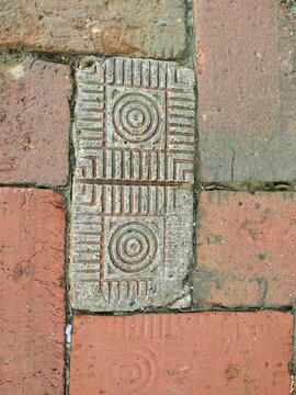 Road paved with patterned antique red bricks