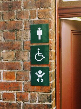 Family-friendly accessible unisex bathroom restroom with signage