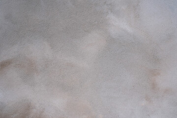Grey-brown concreted wall for internal rooms or external open surface of polished concrete. Cement, sand and stone tones vintage, natural patterns vintage, design artwork floor texture background