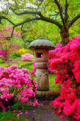 Stone lantern in Japanese garden with blooming flowers, Park Clingendael, The Hague, Netherlands