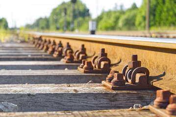 Railroad closeup. Railway tracks, Iron rusty train railway detail over dark stones.