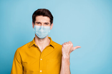 Close-up portrait of his he nice confident healthy guy wearing safety mask demonstrating copy empty blank space place mers cov pneumonia china wuhan isolated pastel color background