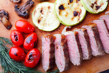 Close-up of marbled beef steak sliced on a cutting board