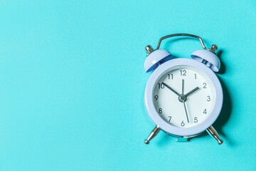 Simply minimal design ringing twin bell vintage classic alarm clock Isolated on blue pastel...