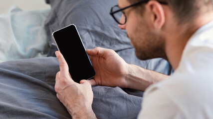 Man Using Cellphone Lying In Bed At Home, Mockup, Panorama