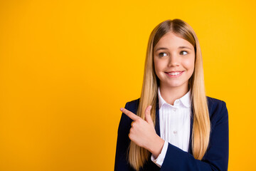 Close-up portrait of her she nice attractive cheerful long-haired schoolchild demonstrating ad advert decision copy empty space isolated bright vivid shine vibrant yellow color background