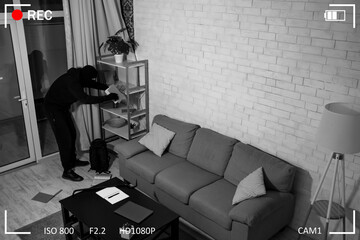 Intruder breaking in an apartment or office to steal