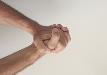 two hands joined in a handshake on a light background