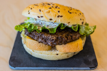 beef burger, cheese, tomatoes, salad