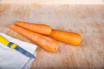 fresh carrots on a wooden table