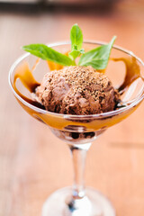 Chocolate ice cream in a glass with caramel topping