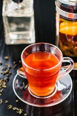 Fruit tea in glass cup on the table in a cafe. French press