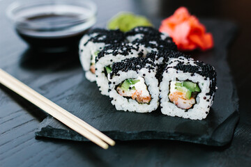 Sushi roll with black caviar on a slate plate
