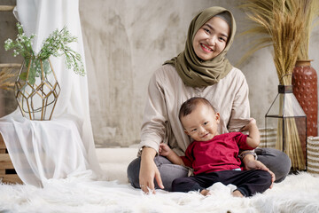 mother veiled with her little boy in the studio