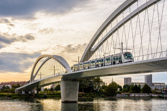 Kehl, Germany - September 16, 2019: A Citadis streetcar on line D of Strasbourg tramway is crossing the Beatus Rhenanus railway bridge to serve Kehl on the other side of the Rhine by a stormy evening.