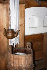 Copper vessel for drinking water (kettle with two spouts) in the interior of a traditional wooden house