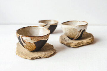 Handmade ceramics in the style of wabi sabi. Brown clay bowls with an abstract pattern.