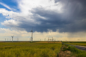 Wind turbines generator for clean energy in the filed on a storm day