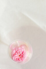 Glass with milk and roses on the table
