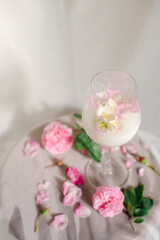 Glass with milk and roses on the table