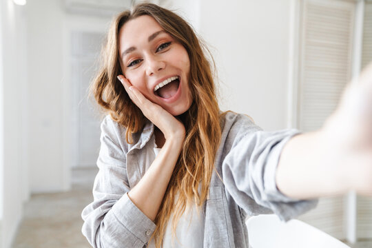 Cheerful attractive young woman taking a selfie