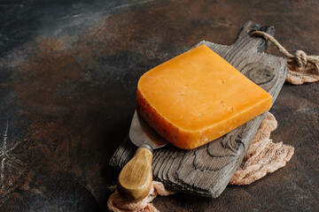 Cheddar cheese on a wooden board