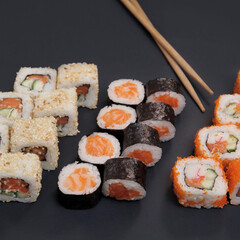 Japanese rolls on black stone background.
