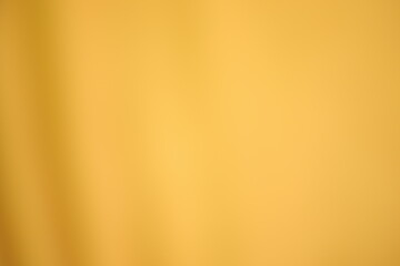 Golden yellow cotton fabric for a soft and smooth background. Elegant graphics.