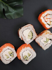 Japanese rolls on black stone background.