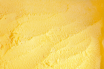 close up vanilla ice cream from above show spoon scratching texture