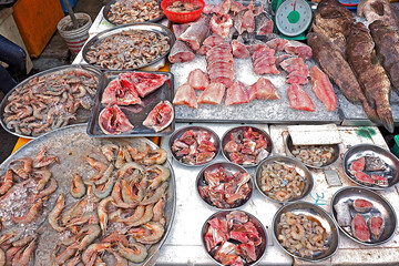 raw cut fillet fish prawn and shrimp at local market