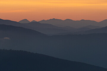 layers of mountains during sunrise