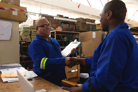 Multi races workers checking hand while smiling