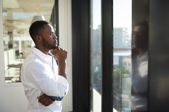 African American business man thoughtful and looking outside 