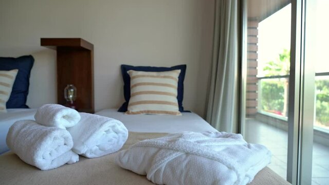 The modern bedroom of the hotel, the house overlooks the veranda and nature.