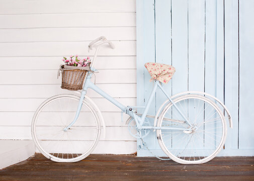 White Bicycle With Beautiful Flower Basket on vintage background